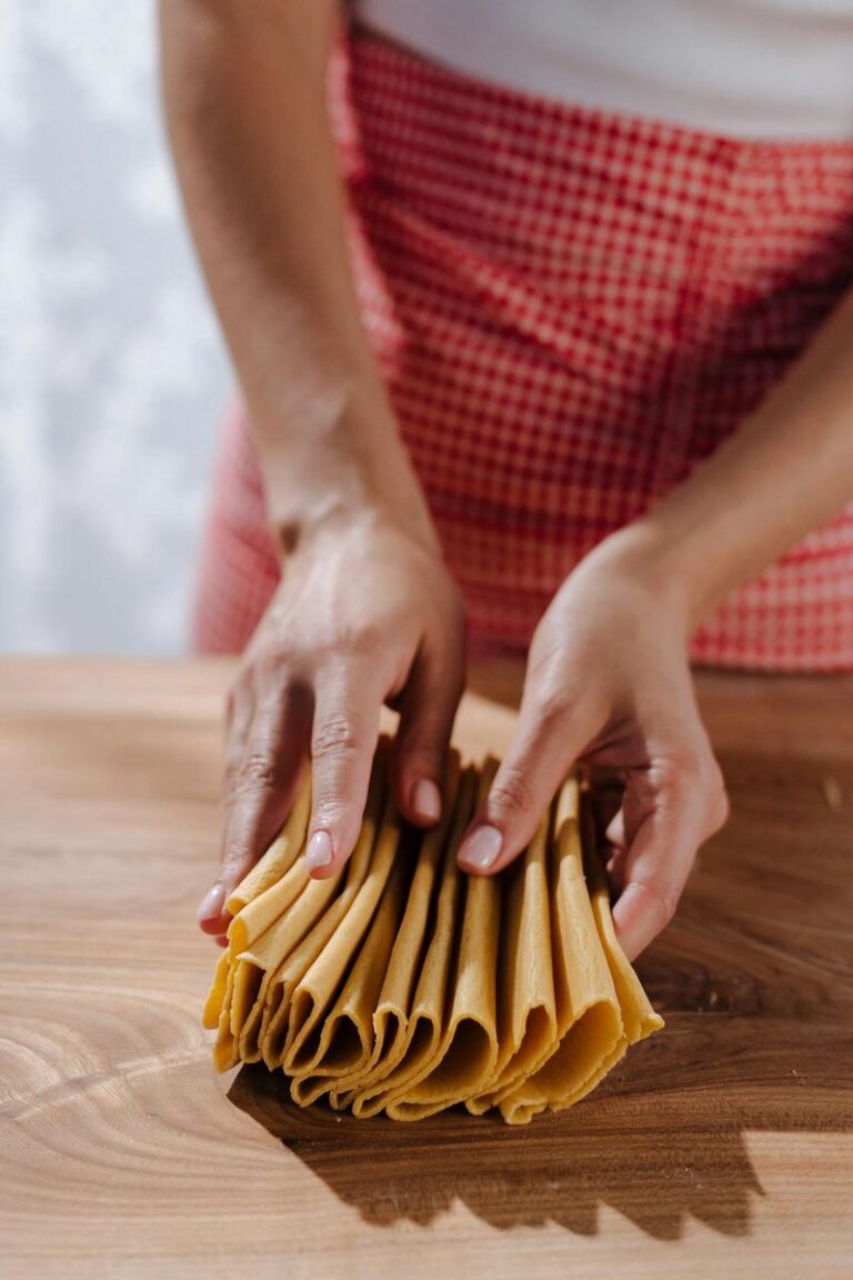 Pasta instructor's hands shaping fresh dough during a cooking class