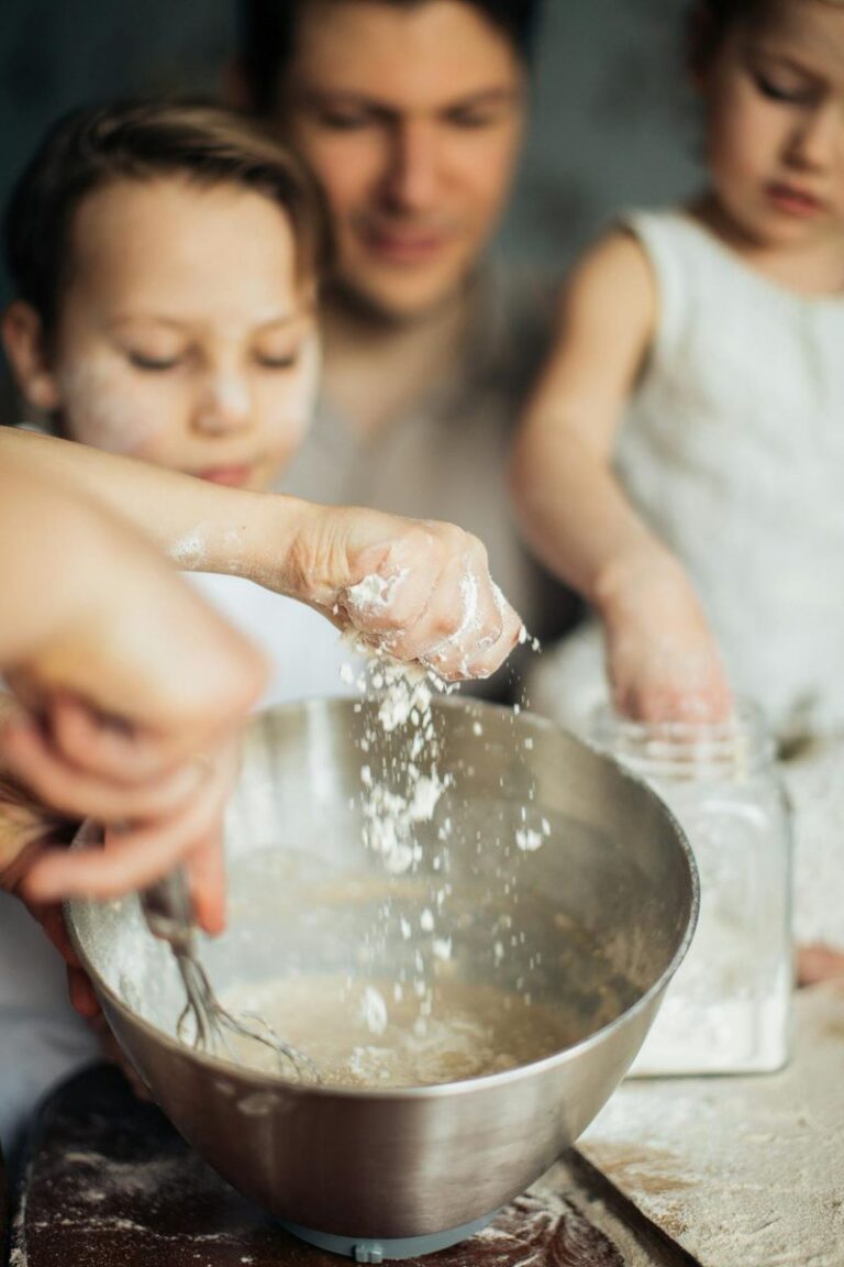 Hands sifting flour for pasta dough preparation