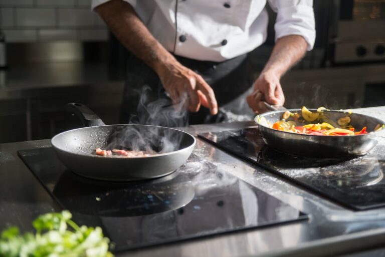 Solo traveler preparing pasta in a sunlit kitchen