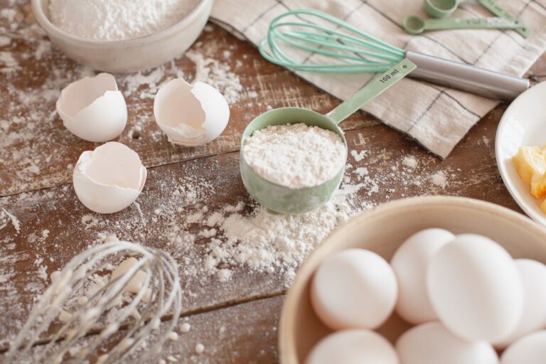 Eggs and flour on a rustic wooden prep surface