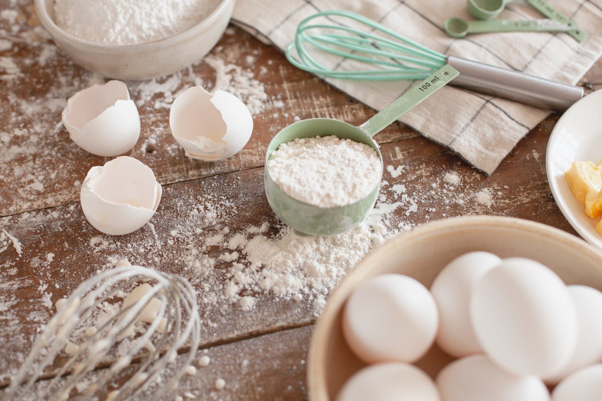 Eggs and flour on a rustic wooden prep surface