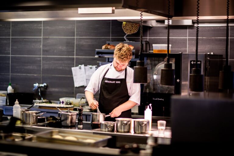 Chef preparing pasta at a professional kitchen station