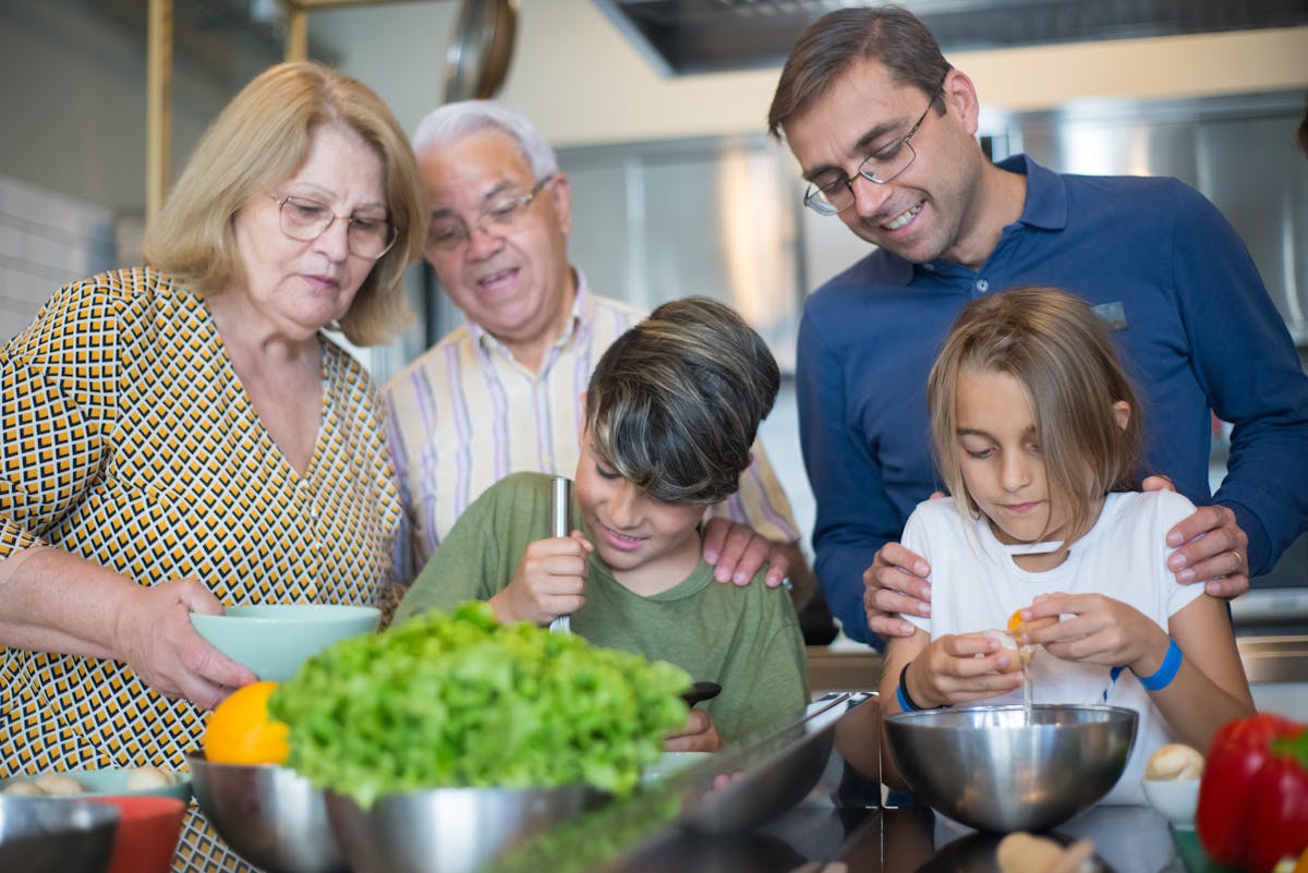 Family cooking pasta together in a home kitchen