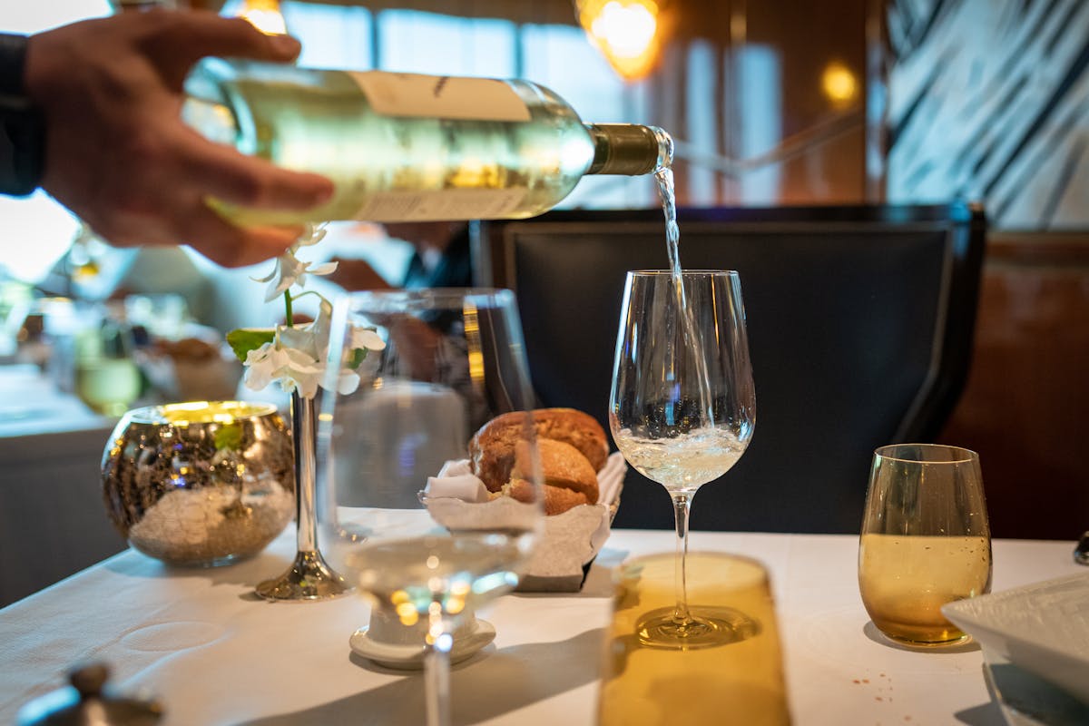 Italian wine being poured into a glass for tasting